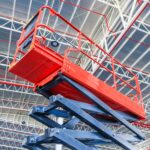 scissor-lift-platform-with-hydraulic-system-elevated-towards-factory-roof-min