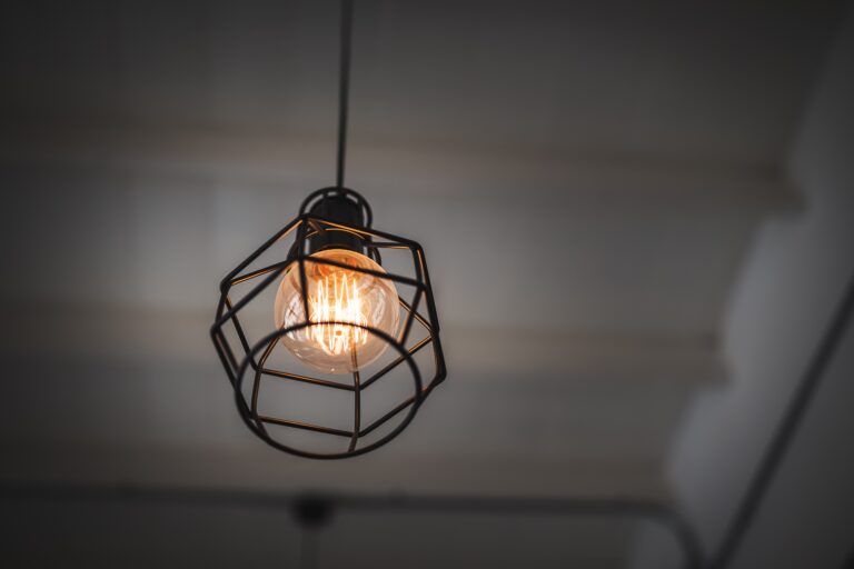 low-angle-view-illuminated-light-bulb-hanging-from-ceiling-min-1