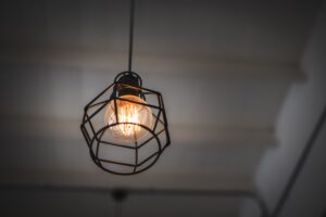 low-angle-view-illuminated-light-bulb-hanging-from-ceiling-min