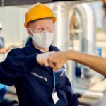 construction-workers-with-face-masks-fist-bumping-coronavirus-epidemic-min