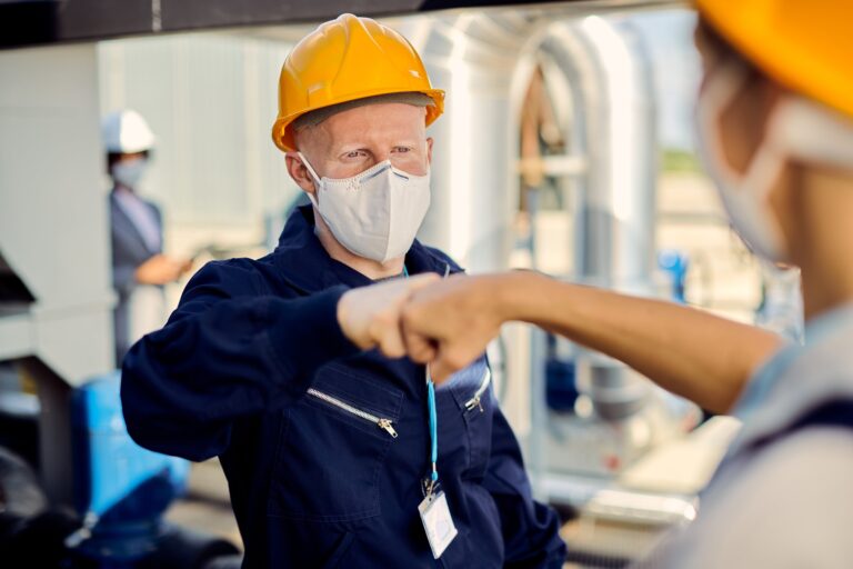 construction-workers-with-face-masks-fist-bumping-coronavirus-epidemic-min